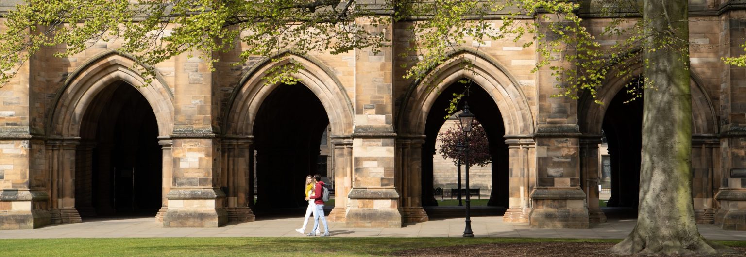 Students walk beside the Cloisters in the East Quadrangle